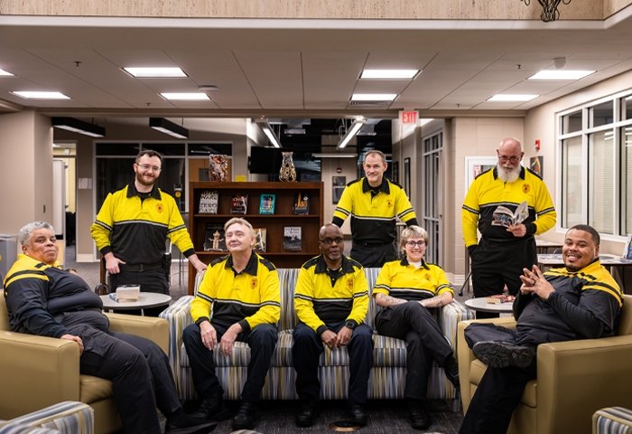 Public Safety officers sitting and standing for a group photo in the library