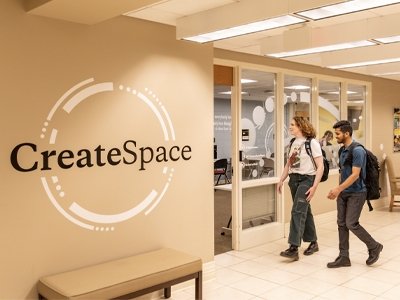 Two students walking into Create Space lab