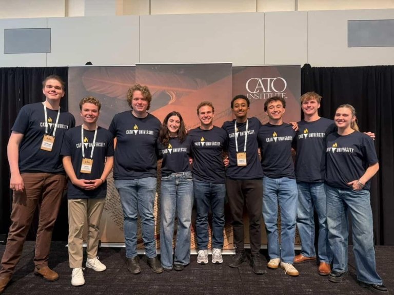 Declan Miller smiles and poses with a few of his peers at the Cato University conference.