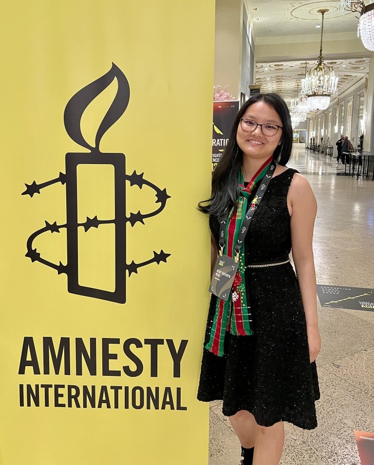 Ruby Nem with a Amnesty International banner.