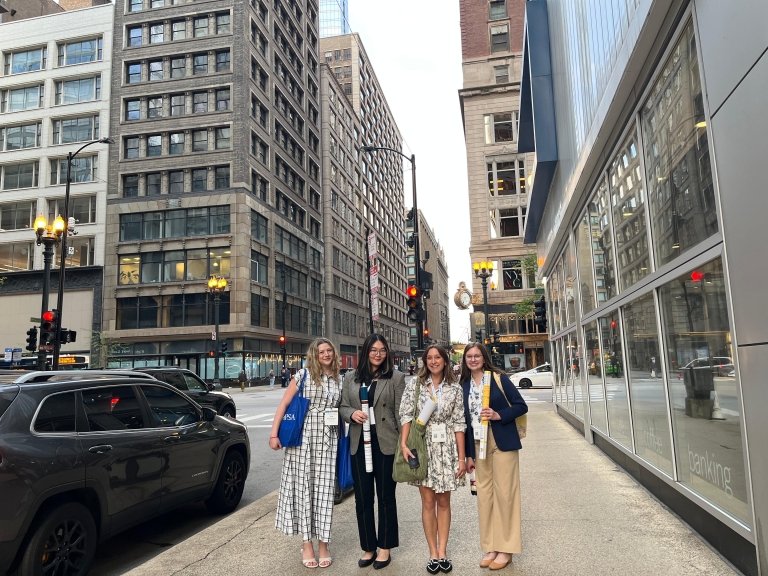 Iris Branstetter, Kennedy Ushiroda, Elena Rodrigues and Caroline Koenig surrounded by Chicago skyscrapers.