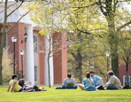 Group of students meeting with professor outside