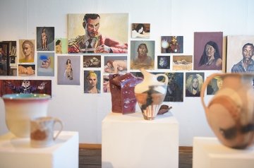 Gallery wall with painting and sculpture on display of students work for RICE Symposium