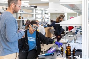 Associate Professor of Chemistry Daniel Scott speaks with a student during his chemistry class.