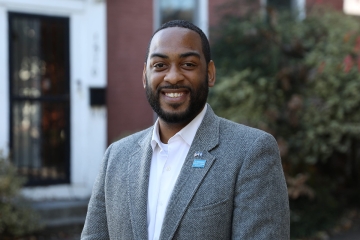 Exterior headshot of Charles Booker, smiling at the camera. 