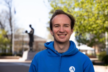 headshot of Joey with blurred out Lincoln statue and surrounding scenery in the background