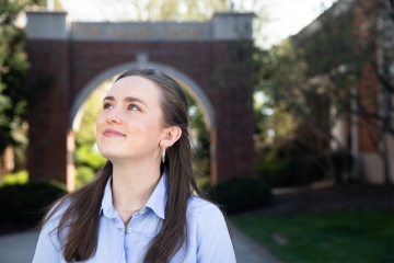 Headshot of Leahy looking up toward the sky, Centre Arch in background