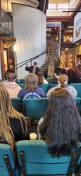 Students listen to Lamont Collins, owner of Louisville’s Roots 101 African American Museum