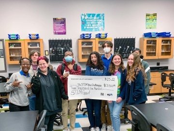 Olivia Kane '18 (center, in blue) teaches at STEM School Chattanooga, where she received a grant for her work in education.