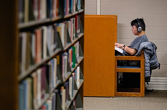 student in library