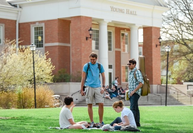 Group of students talking outside Young Hall 
