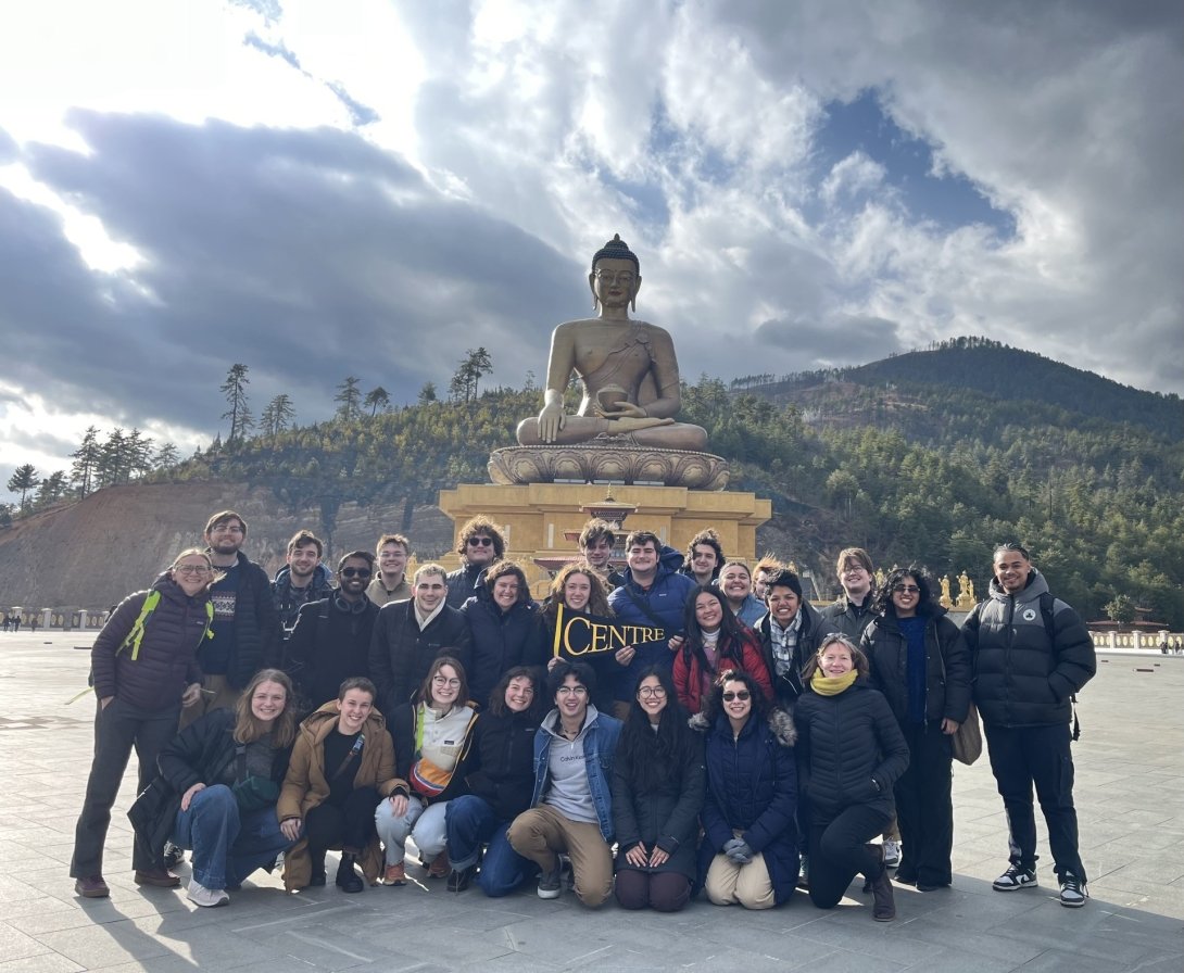 CentreTerm class in Bhutan large group in front of temple statue