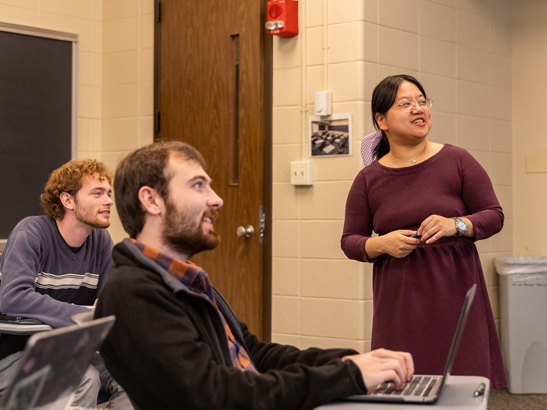 Assistant Professor of Chinese Jingjing Cai (right) teaching with students Kade Schooling (left) and Robbie Harper (center).