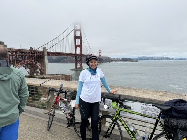 Sarah Murray and her bike in front of the Golden Gate bridge.