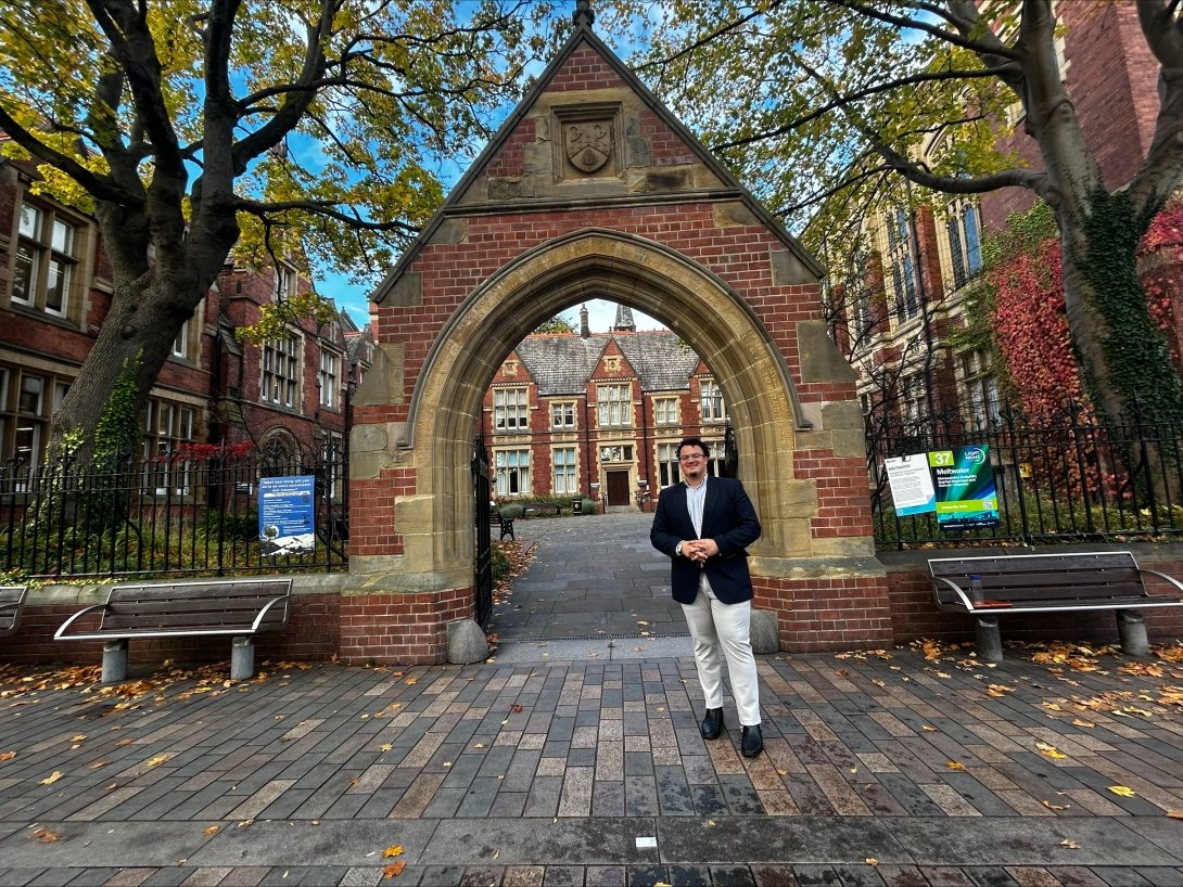 Centre graduate Aiden Jackson poses for a photo in front of a brick archway while he pursues his MBA in England. 