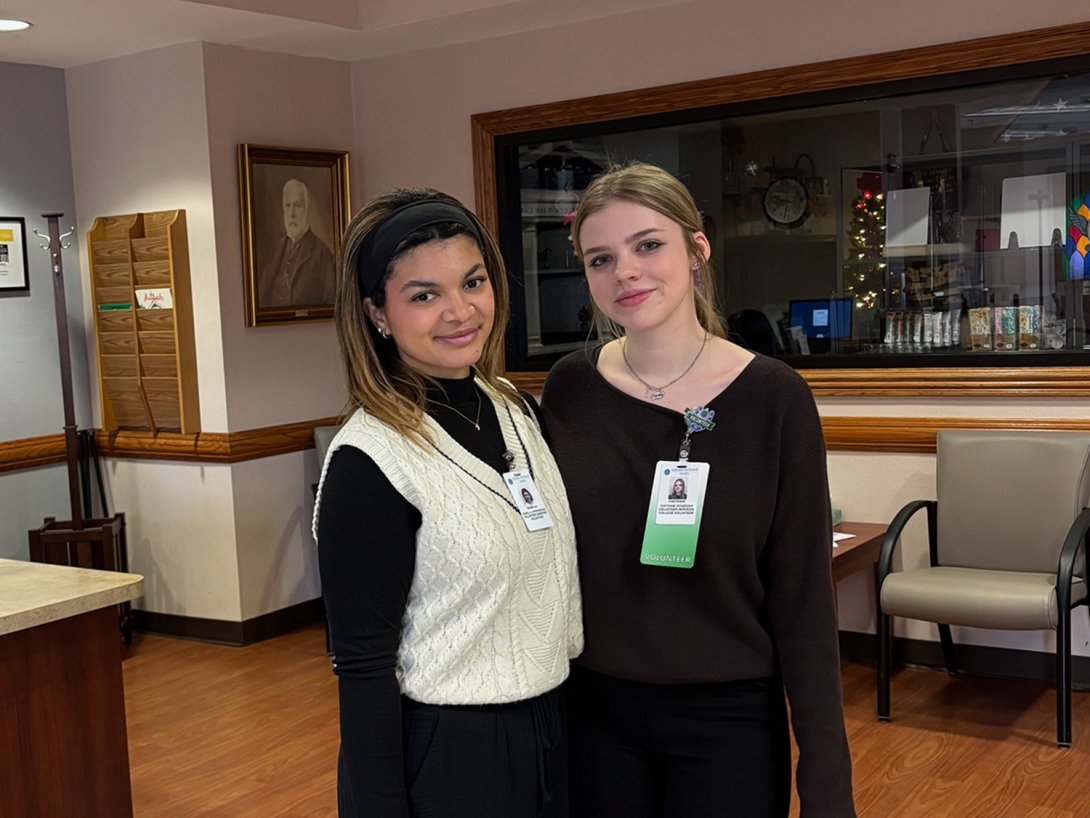 Two students are posing for a photo while volunteering with Ephraim McDowell Health.